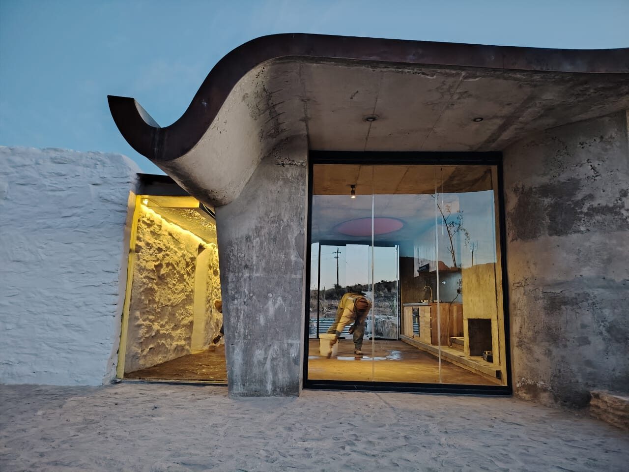 Sheep Herder's Cottage — concrete shell roof and glass at dusk